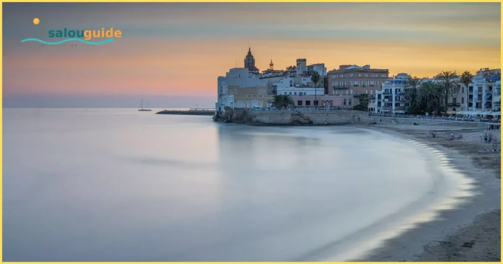 Sitges shimmering beside the Mediterranean, with golden beaches, whitewashed streets, and a gentle Catalan seaside charm